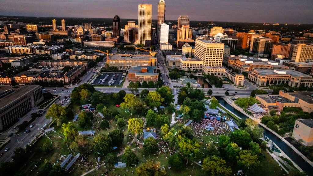 Downtown Indy over a music festival during sunset