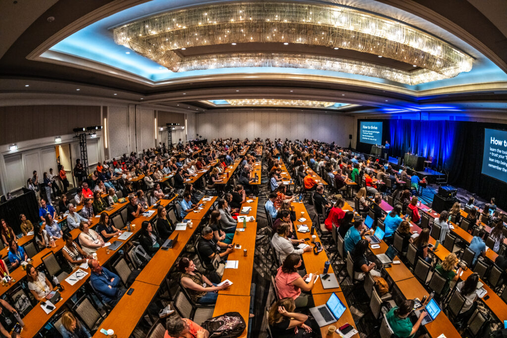 Large crowd of attendees at a corporate conference